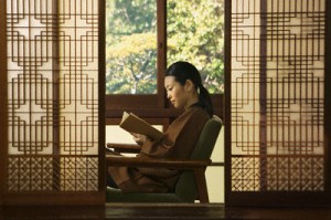 Woman Reading Book --- Image by © Sven Hagolani/Corbis