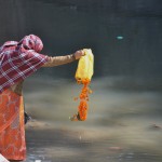 Hindu worshipper performing a prayer to the river